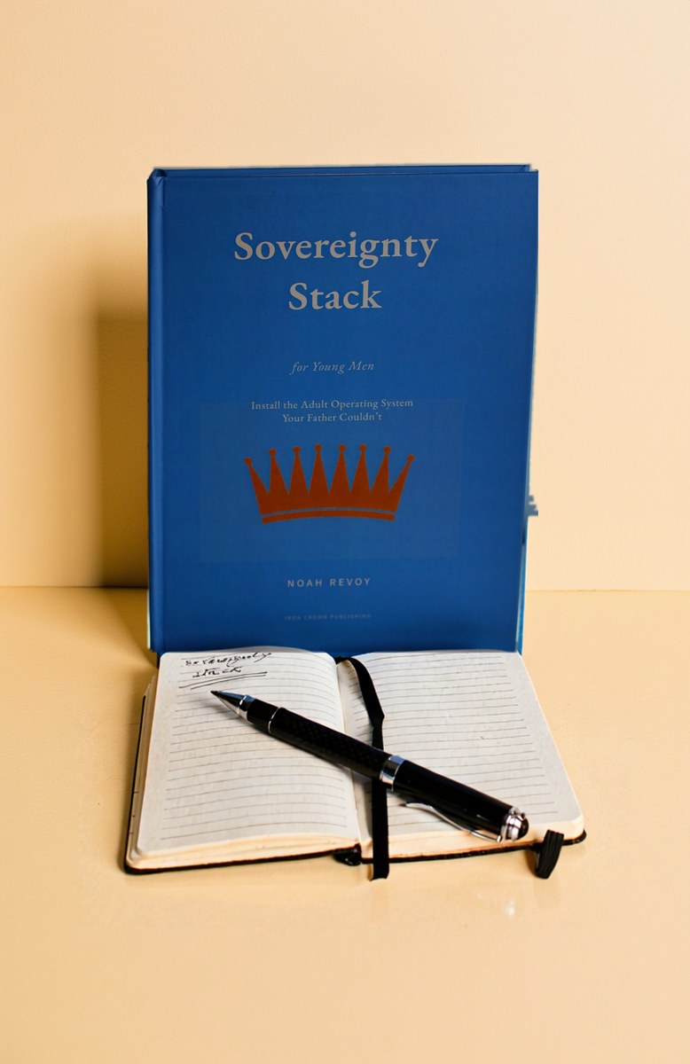 The hardcover photographed on a cream ground beside a notebook.